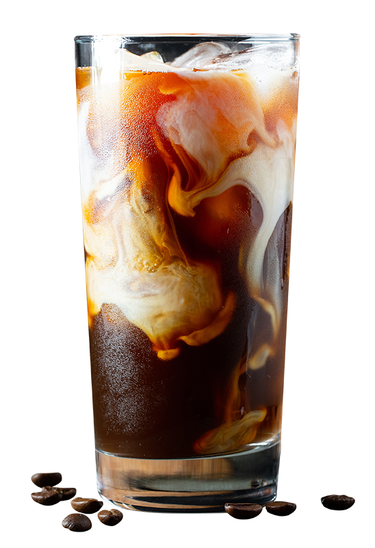 Highball glass with milk swirling through dark coffee coloured cocktail.